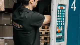 Worker entering and operating a warehouse loading bay