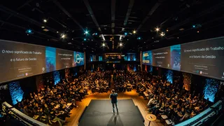 Host speaking to an audience on the main stage